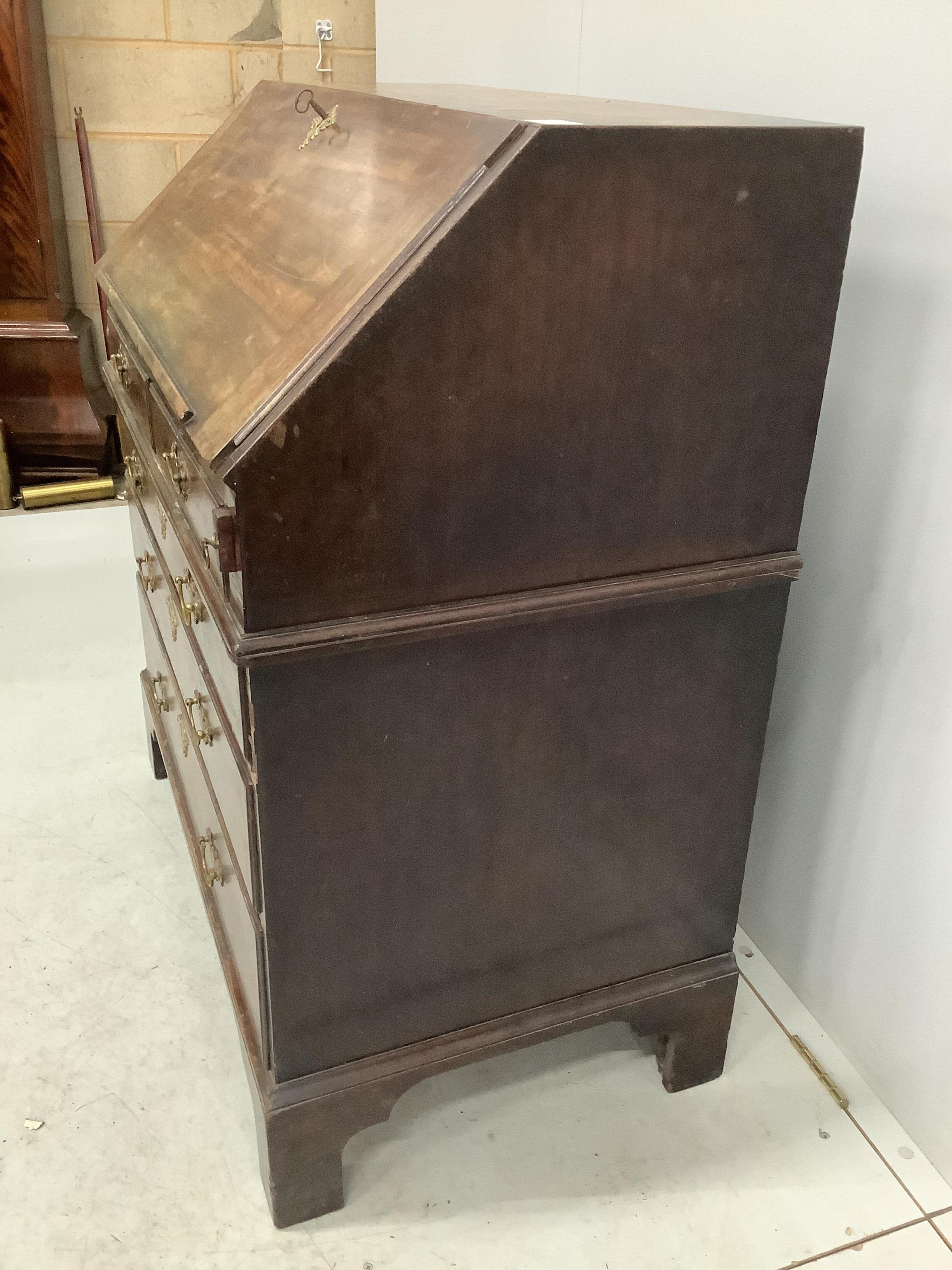 A George III mahogany bureau, width 96cm, depth 56cm, height 106cm. Condition - poor to fair, top with two areas of lost moulding